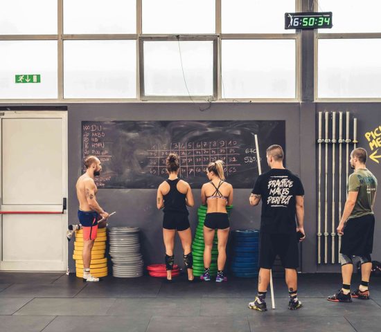 group of people planning training gym crossfit writing blackboard - planning, training, athletes concept