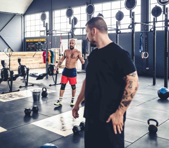 two young men training gym crossfit